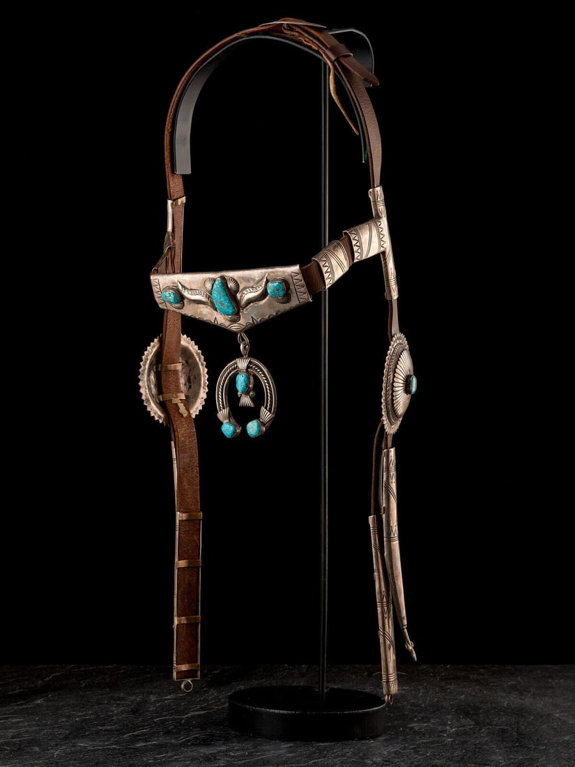 Floyd Arviso (Diné, act. since 1960s) Silver and High Grade Turquoise Headstall: Floyd Arviso (Diné, act. since 1960s) Silver and High Grade Turquoise Headstall heavily stamped with the cheek conchas, browband, and naja set with turquoise; marked FA length 24 inches This lot 