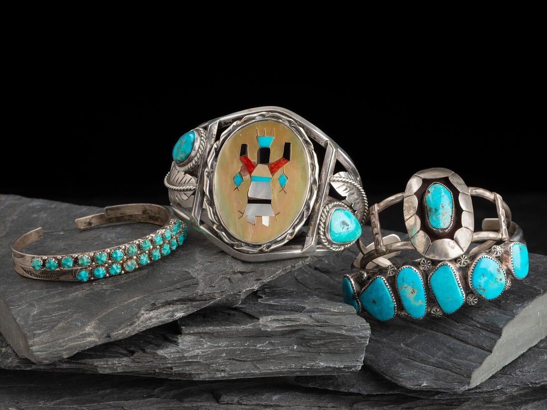 Navajo Silver Cuff Bracelets: Navajo Silver Cuff Bracelets third quarter 20th century lot of 5, includes: an example with mosaic inlay Gan Dancer, not marked width 2-1/8 inches, interior circumference 5-1/2 inchs + gap length 1-1/