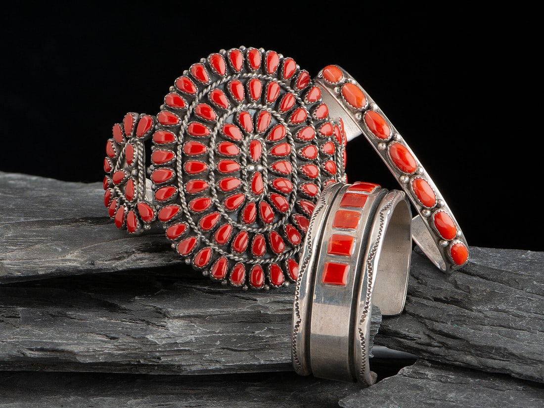 Navajo Silver and Coral Cuff Bracelets: Navajo Silver and Coral Cuff Bracelets second half 20th century lot of 3, includes: a cluster example; marked K STERLING width 2-3/4 inches, interior circumference 5-1/8 inches + gap length 1-3/8 inch