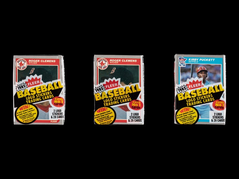A Collection of Unopened 1985 Fleer Baseball Card Cello Packs with Kirby Puckett and Roger Clemens R: A Collection of Unopened 1985 Fleer Baseball Card Cello Packs with Kirby Puckett and Roger Clemens Rookie Cards Visible (x3) Property from a Midwest Collector This lot is located in Chicago.<b