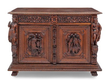 A Swiss Black Forest Carved Hunt Cabinet