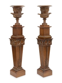 A Pair of Neoclassical Style Carved Campagna Form Urns on Pedestals