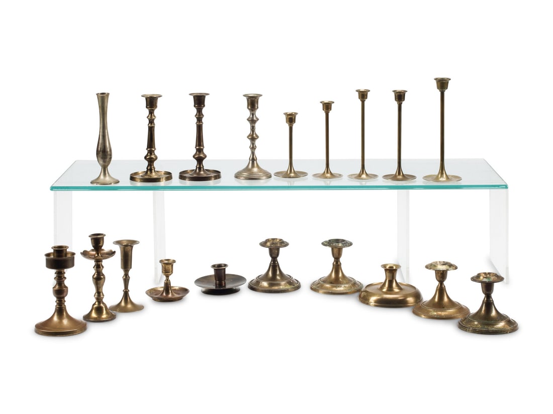 A Collection of Nineteen Brass Candlesticks: A Collection of Nineteen Brass Candlesticks 20th Century Height of tallest 8 inches. This lot is located in Chicago.