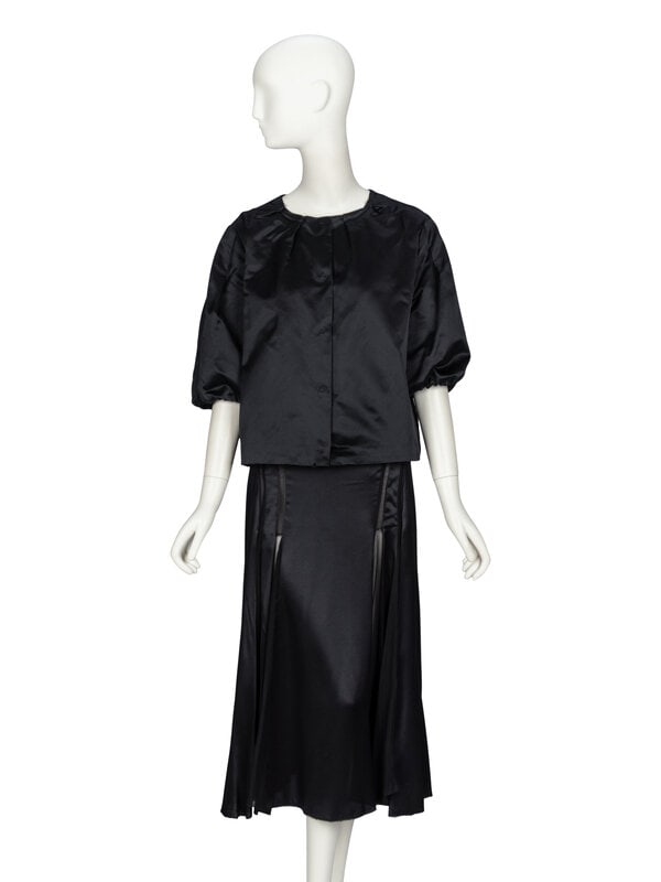Prada & Calvin Klein, Silk Jacket & Skirt: Prada & Calvin Klein, Silk Jacket & Skirt JACKET Evening jacket in black duchesse silk. Round collarless pleated neckline. Elbow-length puff sleeves with elasticated sleeve hems. Sligh