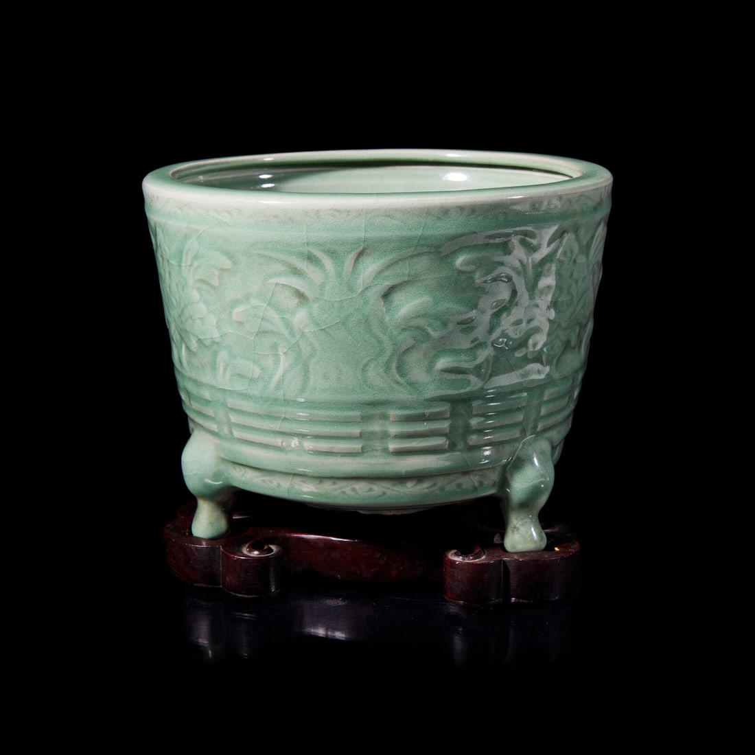 A Chinese Longquan Celadon Glazed Porcelain Incense Burner 龍泉青瓷花: A Chinese Longquan Celadon Glazed Porcelain Incense Burner 龍泉青瓷花卉紋三足大香爐 Heavily potted with a broad cylindrical body