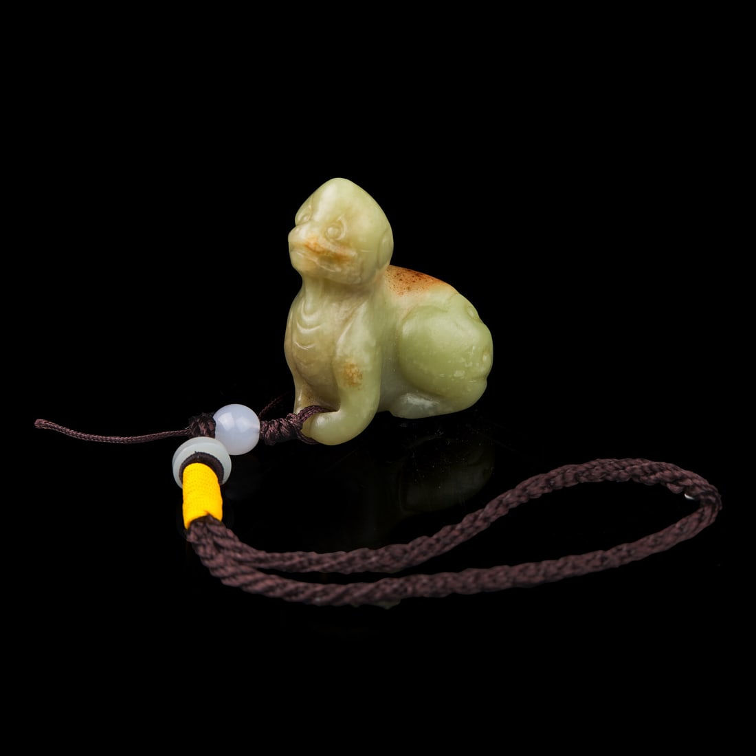 A Chinese Russet and Yellow Jade Figure of a Mythical Beast 青黃玉瑞獸