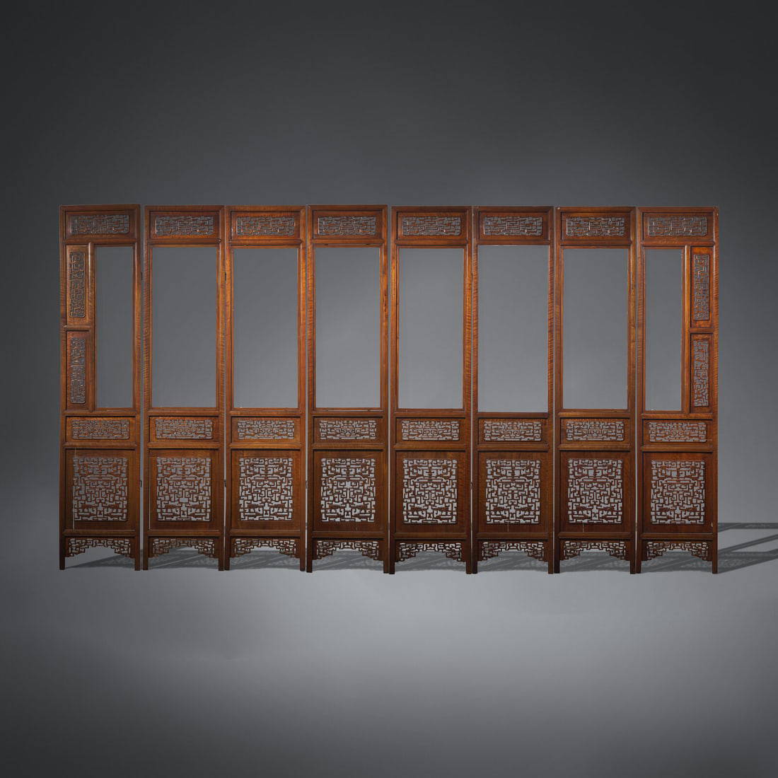 A Large Chinese Carved Hardwood, Possibly Longyan Mu, and Glass Eight-Panel Screen 或為