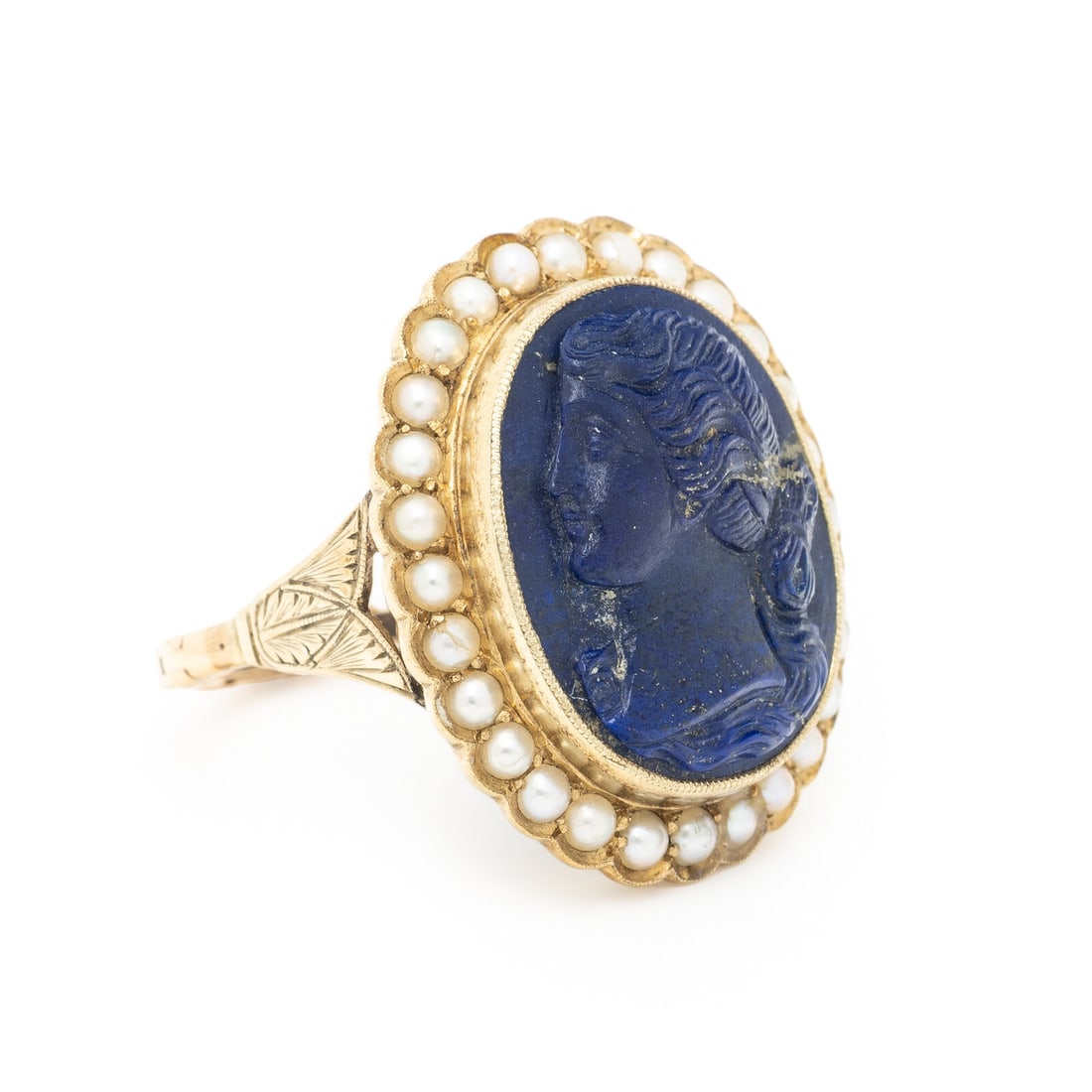 LAPIS LAZULI CAMEO AND SEED PEARL RING: LAPIS LAZULI CAMEO AND SEED PEARL RING Oval lapis lazuli cameo measuring approximately 19.65 x 15.60 mm and seed pearls. Yellow gold. Ring size 10. Gross weight: 7.30 dwt. Sold for the benefit of Shri