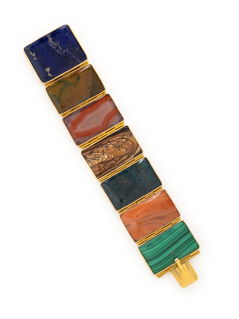 ANTIQUE, HARDSTONE PLAQUE BRACELET: ANTIQUE, HARDSTONE PLAQUE BRACELET Plaques of malachite, bloodstone, lapis lazuli, and agate. Yellow gold. 7 inches long, 1 3/8 inches wide. Gross weight: 39.85 dwt. Sold for the benefit of Shriners H