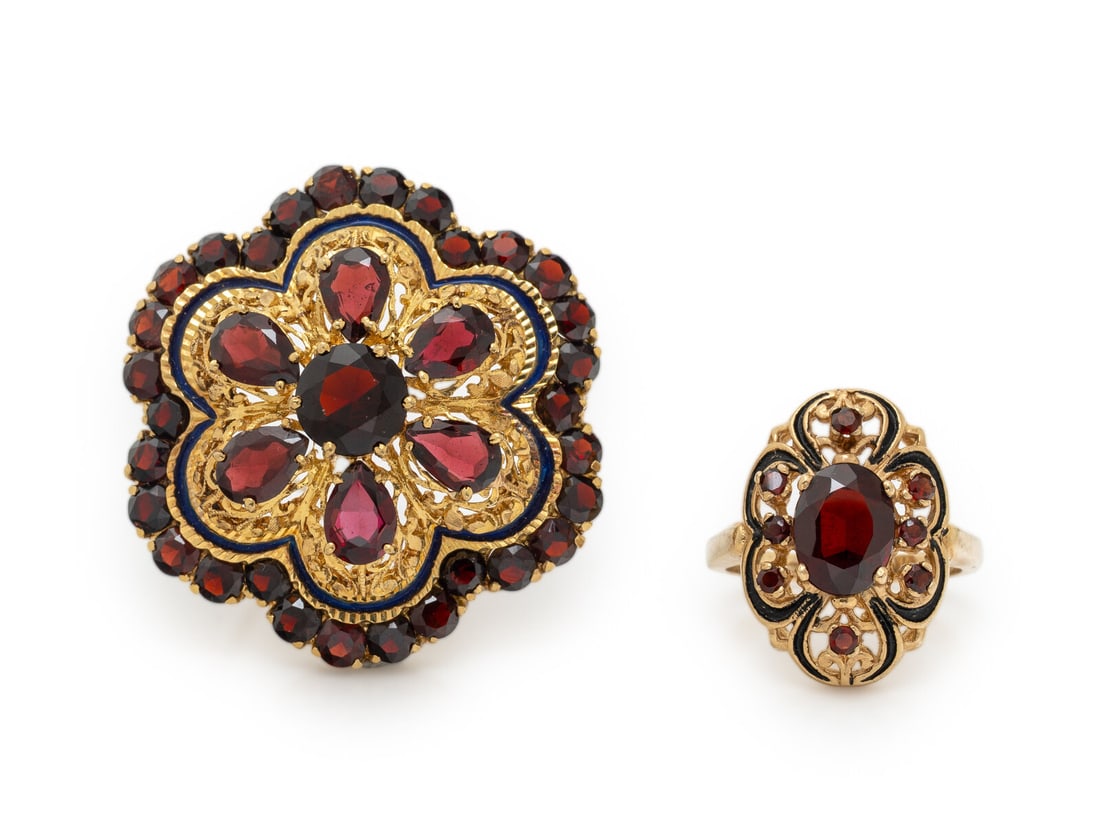 GARNET, ENAMEL, AND YELLOW GOLD BROOCH AND RING: GARNET, ENAMEL, AND YELLOW GOLD BROOCH AND RING Round, oval cut, and pear shape garnets, and blue and black enamel. 18 karat yellow gold and yellow gold. Brooch: 1 1/4 x 1 1/4 inches. Ring size 6. Bro