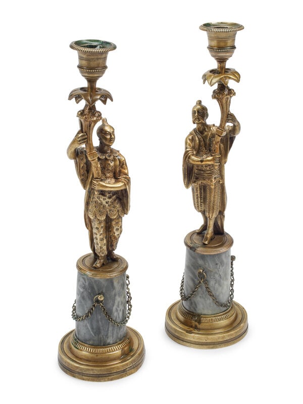 A Pair of French Bronze Figural Candlesticks on Marble Bases: A Pair of French Bronze Figural Candlesticks on Marble Bases 19th Century Height 12 inches. This lot is located in Chicago.