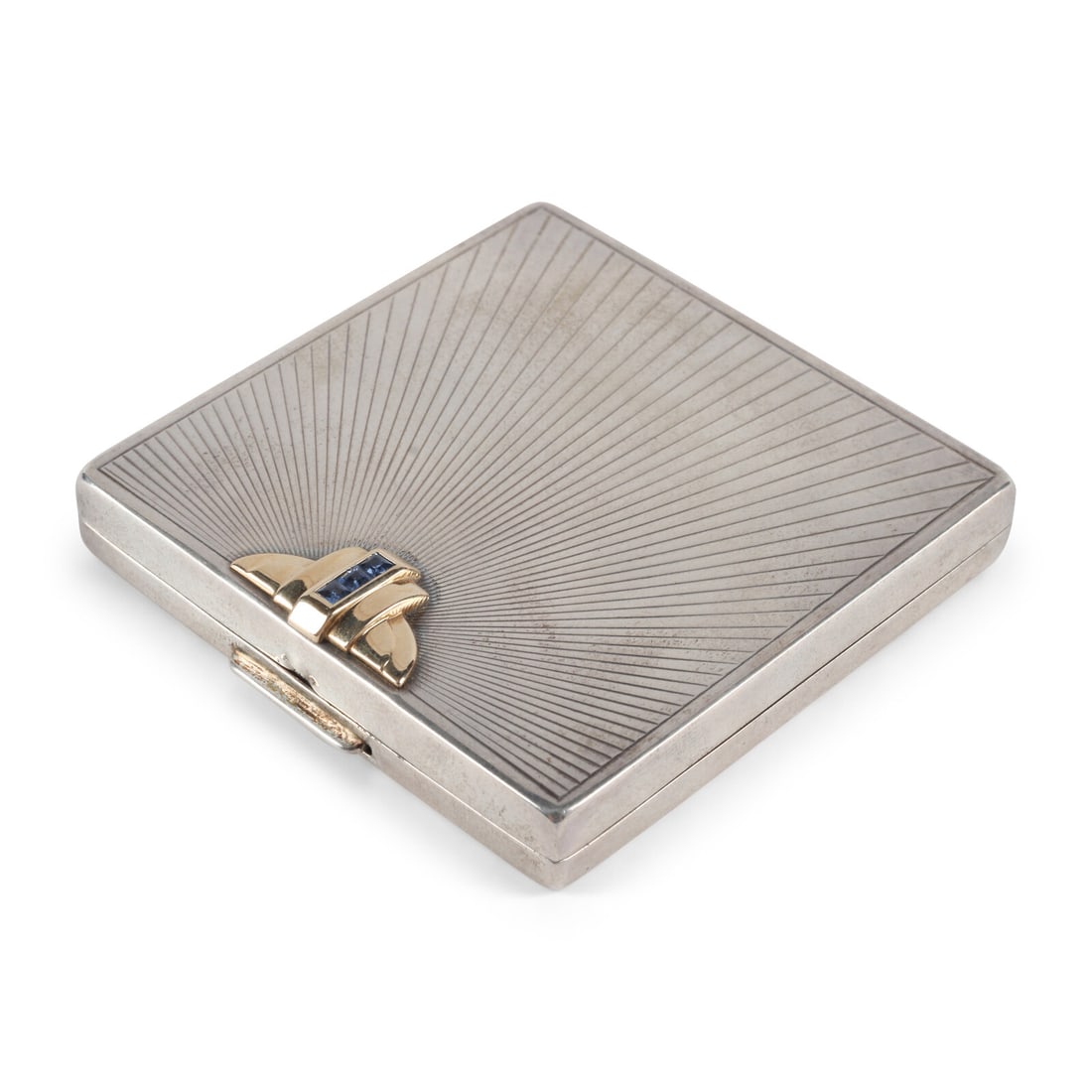 A Cartier-Retailed Silver, 14 Karat Gold and Sapphire Compact: A Cartier-Retailed Silver, 14 Karat Gold and Sapphire Compact Early 20th Century marked for maker, Sterling, and 14k to interior edge Height 3/8 x width 2 1/4 x 2 1/4 inches. This lot is located in Ch