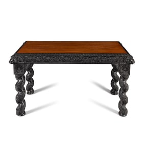 An Anglo-Colonial Carved Ebony and Satinwood Center Table