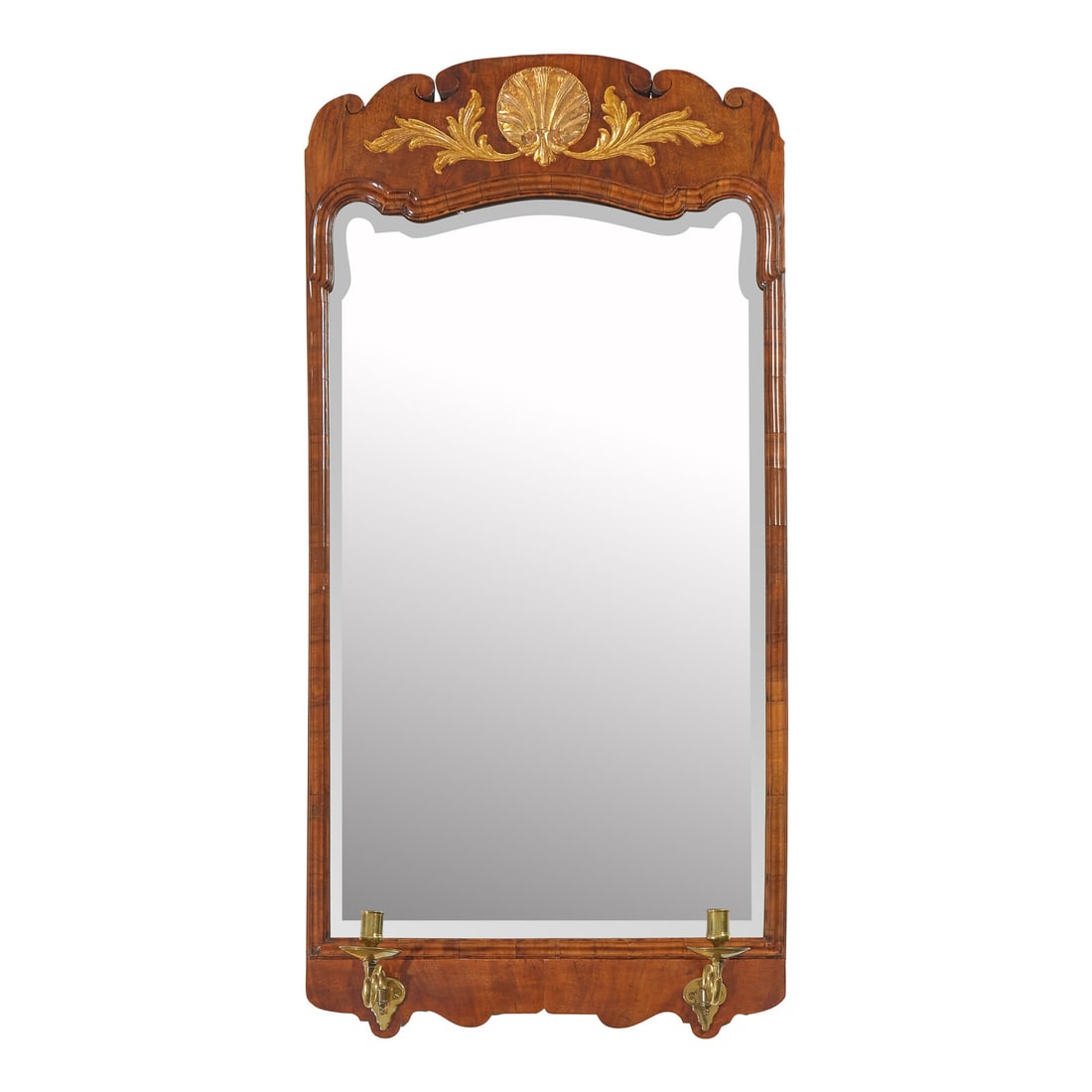 A George II Mahogany and Parcel-Gilt Looking Glass: A George II Mahogany and Parcel-Gilt Looking Glass Circa 1750 the top with carved and gilded shell and foliage, with detachable brass candlearms. 42 1/2 x 20 3/4 inches. This lot is located in Philade