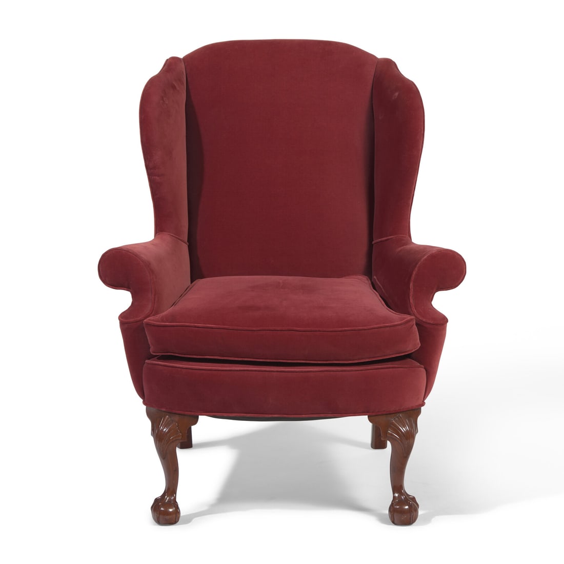 A Chippendale Carved Mahogany Easy Chair: A Chippendale Carved Mahogany Easy Chair Philadelphia, Pennsylvania, Circa 1760-1780 on cabriole legs with shell-carved knees, ending in ball-and-claw feet, upholstered in modern red velvet. Height 46