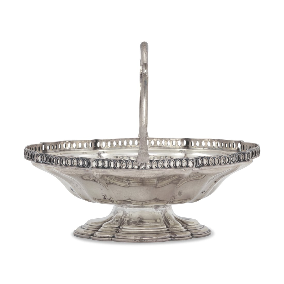 A George V Sterling Silver Footed Sugar Basket: A George V Sterling Silver Footed Sugar Basket Mappin & Webb, Ltd., London, 1911 with scrolled handle, scalloped and reticulated rim, marked to interior well edge and underside. Height 6 1/2 x wid