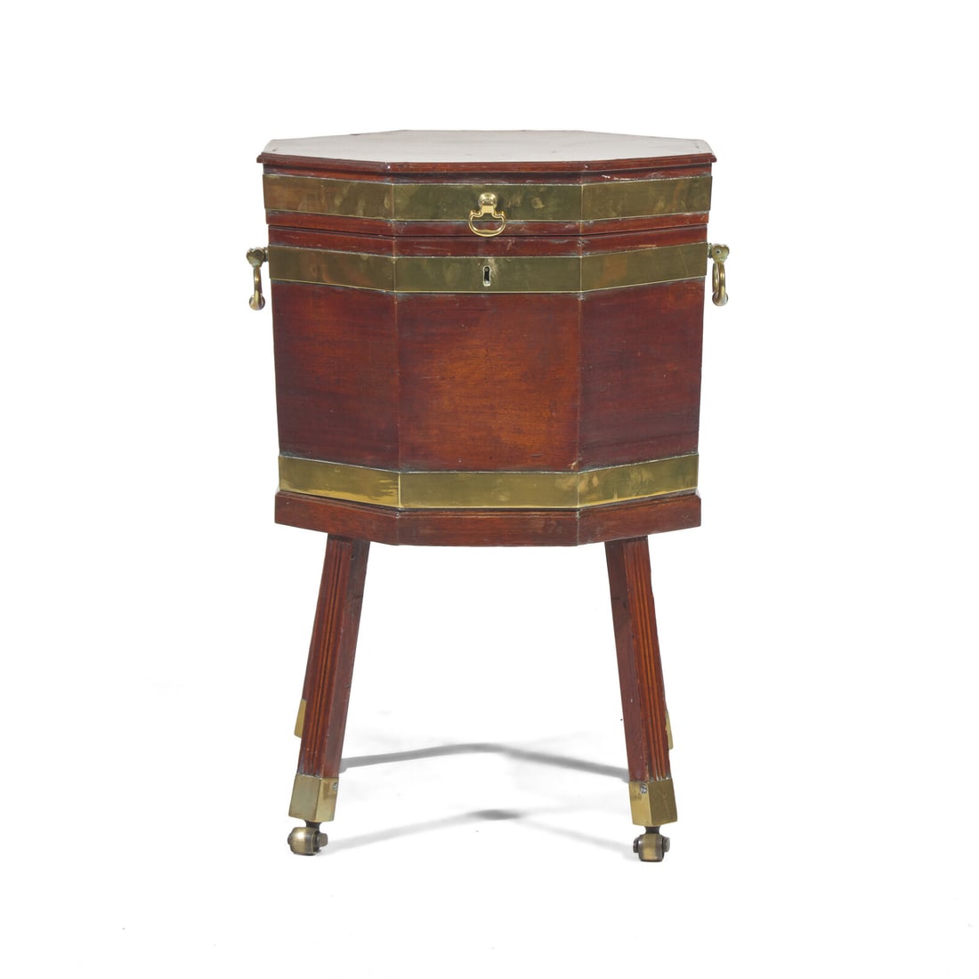 A George III Octagonal Brass-Bound Mahogany Cellarette: A George III Octagonal Brass-Bound Mahogany Cellarette Late 18th Century in two parts, the upper section with lift-lid top, two brass handles, the lower section on fluted legs with brass sabots and ca