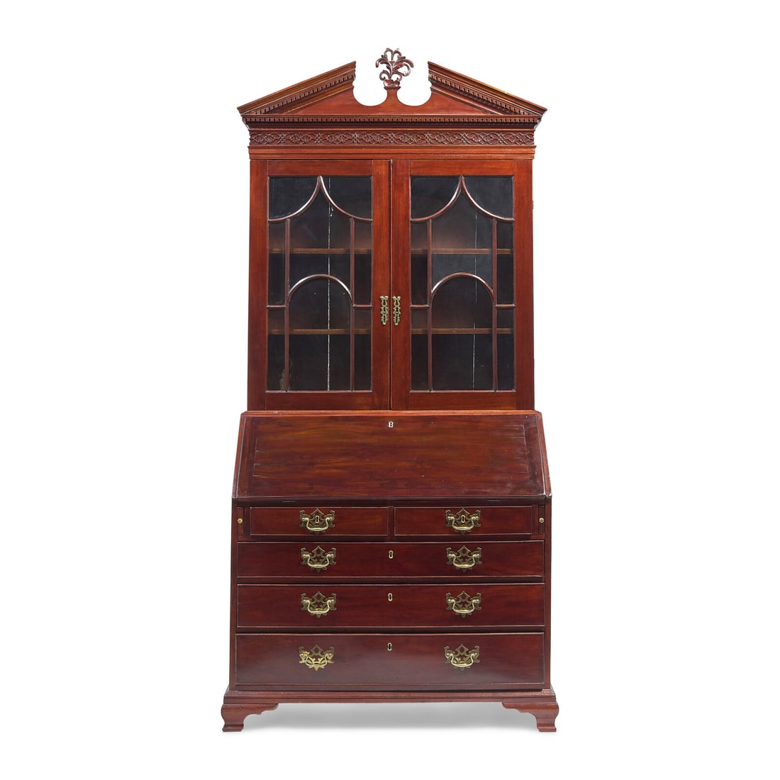 A George III Mahogany and Satinwood Secretary Bookcase: A George III Mahogany and Satinwood Secretary Bookcase Circa 1790 in two parts, the upper section with broken arch pediment having dentil molding and blind fretwork, centered by carved and pierced car