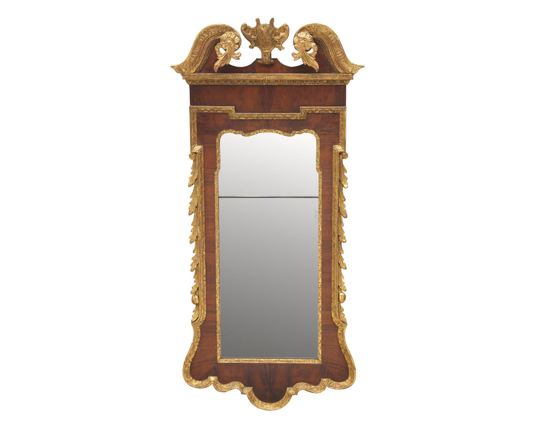 A George III Mahogany Veneered and Parcel-Gilt Looking Glass: A George III Mahogany Veneered and Parcel-Gilt Looking Glass Circa 1770 surmounted by eagle cartouche. 46 x 25 1/4 inches. This lot is located in Philadelphia. Provenance: A New York collection.