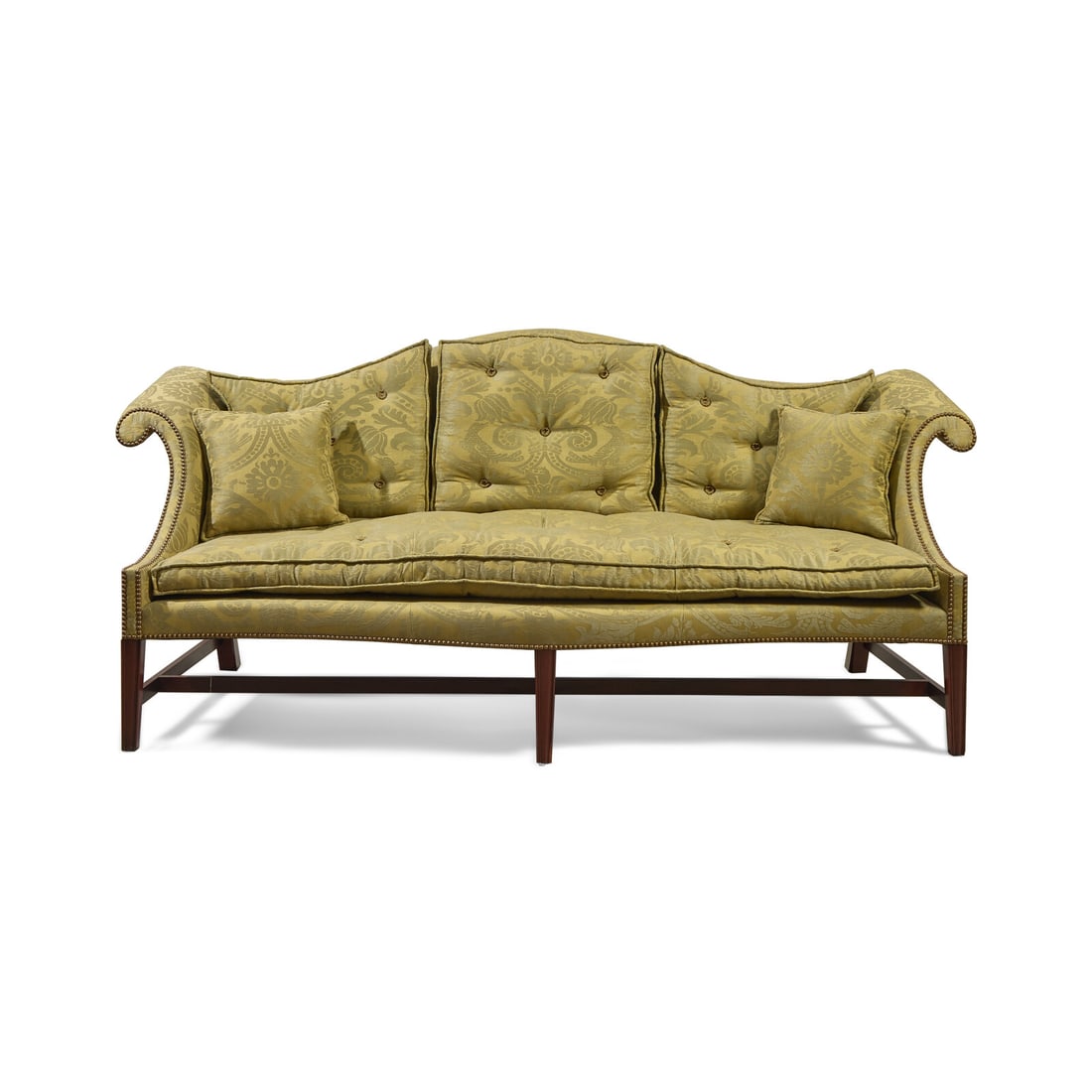 A Chippendale Mahogany Camelback Sofa: A Chippendale Mahogany Camelback Sofa 20th Century upholstered in green damask, with custom tufted cushions and pillows. Height 39 1/2 x width 89 1/2 x depth 33 inches. Property from the Wetherill Fam