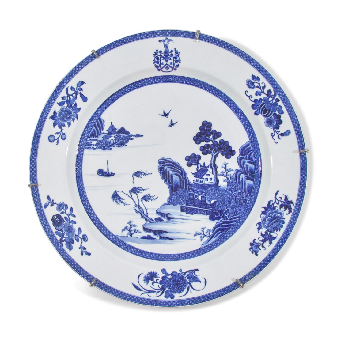A Chinese Export Porcelain Blue and White Armorial Charger: A Chinese Export Porcelain Blue and White Armorial Charger 18th Century the upper rim bearing coat-of-arms surmounted by trumpeting angel. Diameter 16 3/4 inches. This lot is located in Philadelphia.