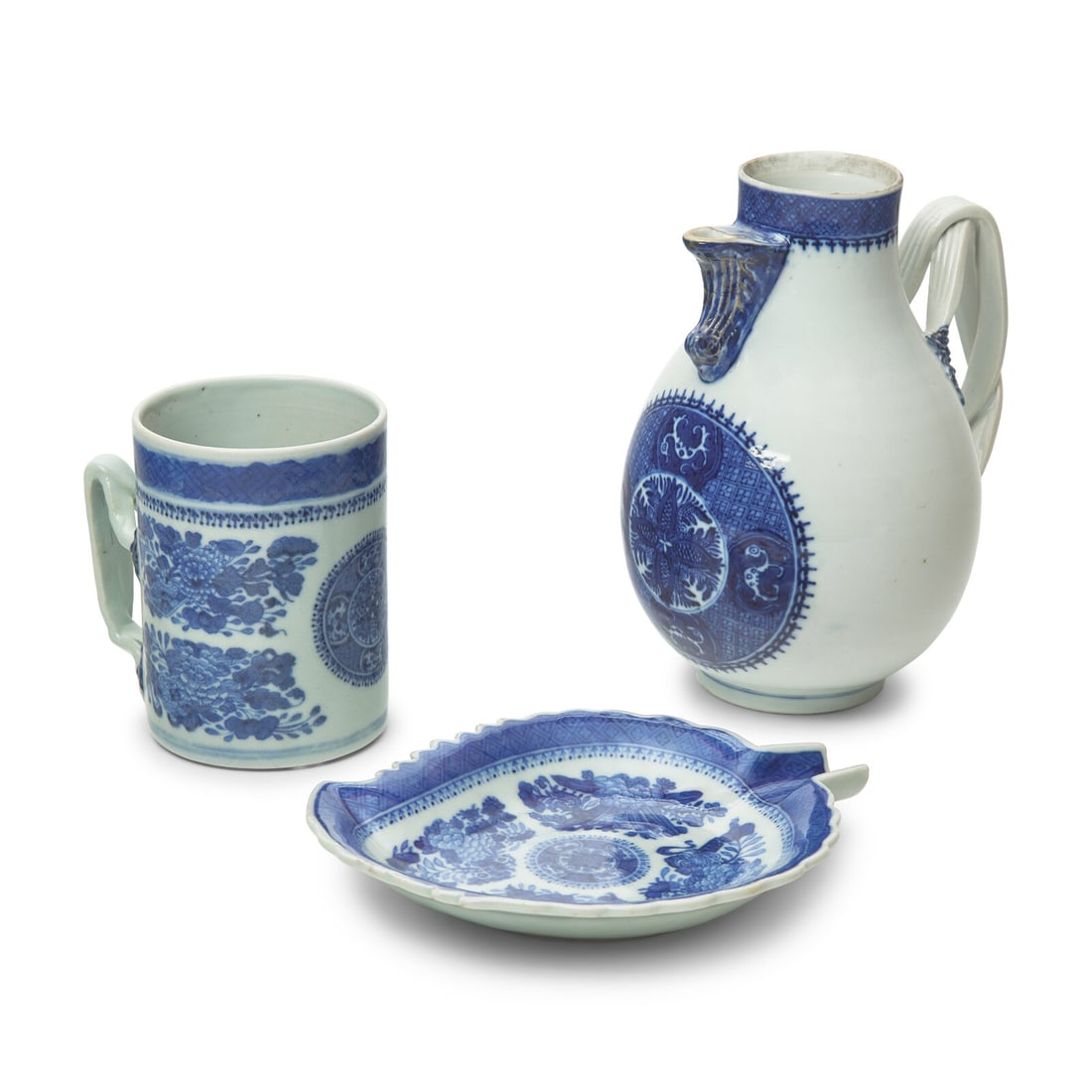 Three Chinese Export Porcelain Fitzhugh Tablewares: Three Chinese Export Porcelain Fitzhugh Tablewares Late 18th / Early 19th Century comprising a jug, a mug, and a leaf-shaped spoon rest. Height 7 3/4 x width 6 1/4 x depth 5 inches (jug). This lot is