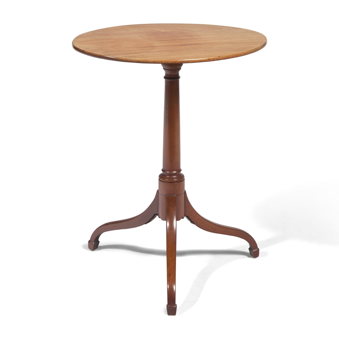 A Federal Mahogany Tilt-Top Candlestand: A Federal Mahogany Tilt-Top Candlestand Circa 1800 with oval top, on tapered shaft terminating in three scrolled legs with spade feet. Height 28 x width 22 7/8 x depth 15 5/8 inches. This lot is locat