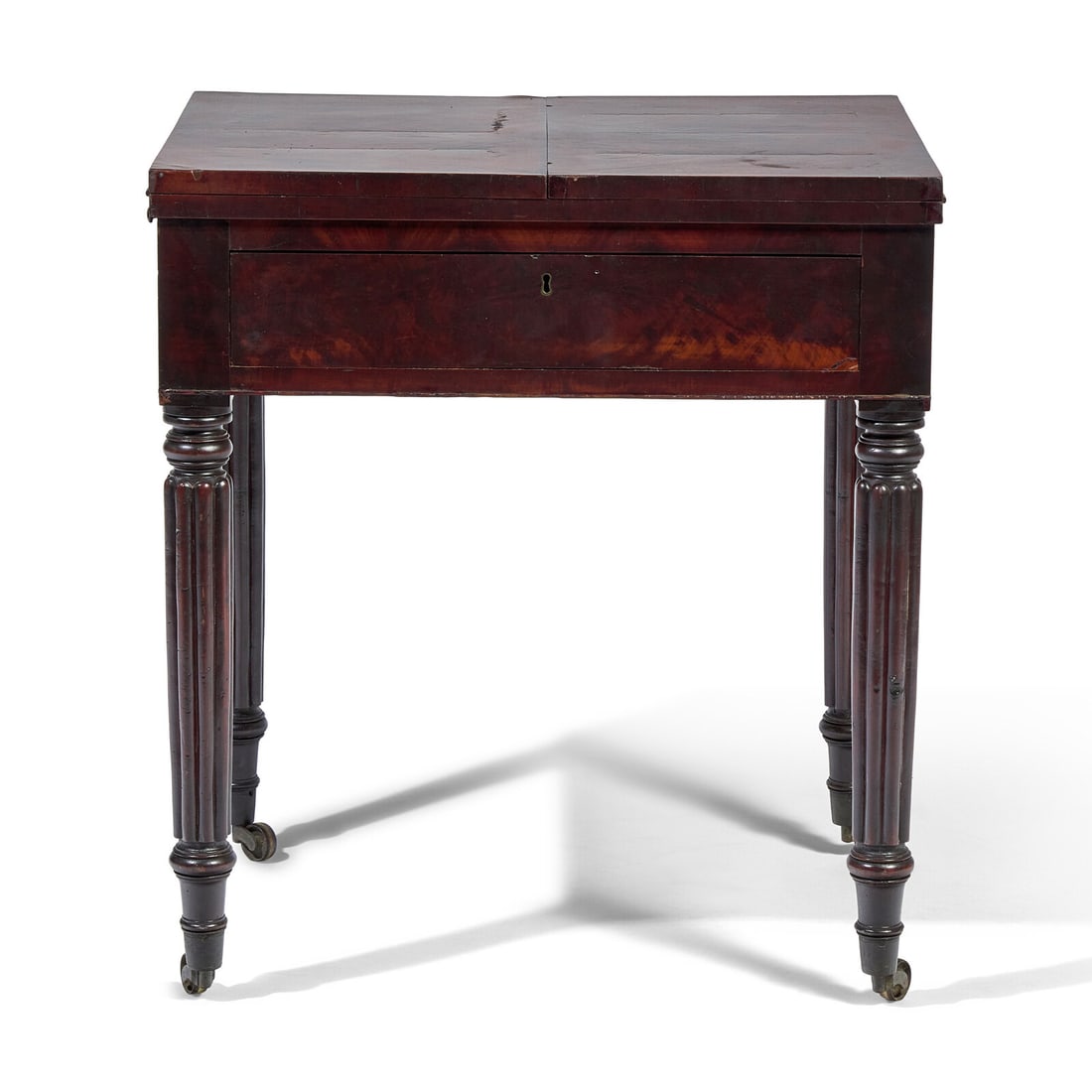 A Late Federal Carved Mahogany Writing Table: A Late Federal Carved Mahogany Writing Table Baltimore, Maryland, Circa 1820 with flip up top, opening to reveal an original green baize writing surface, on prominent reeded legs ending in brass caste