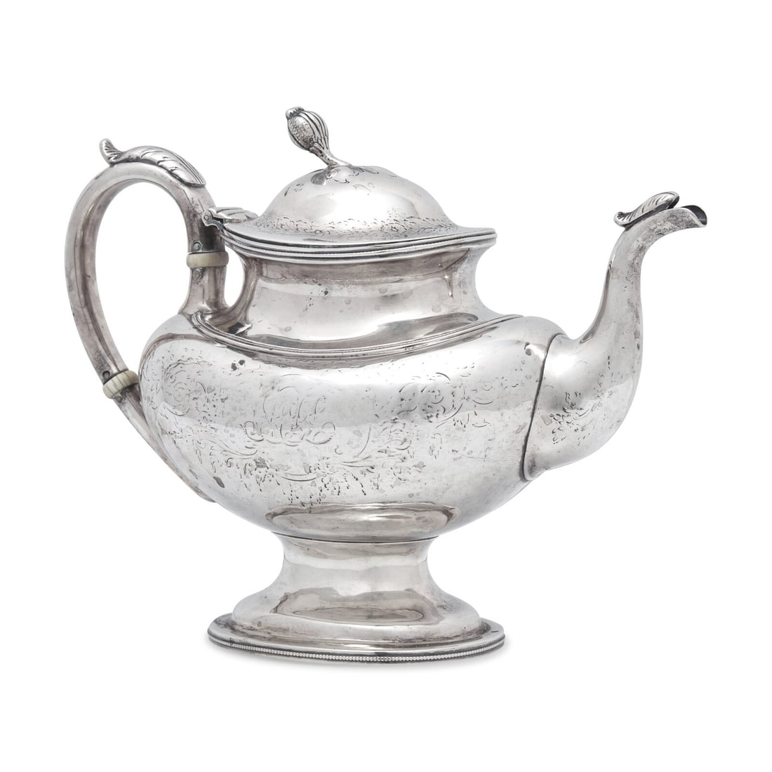 A Coin Silver Teapot: A Coin Silver Teapot Jones, Ball & Poor (active 1846-1853), Boston, Massachusetts, Circa 1850 the lid with melon-form finial, the body engraved with faint monogram, marked to underside. Height 8 x