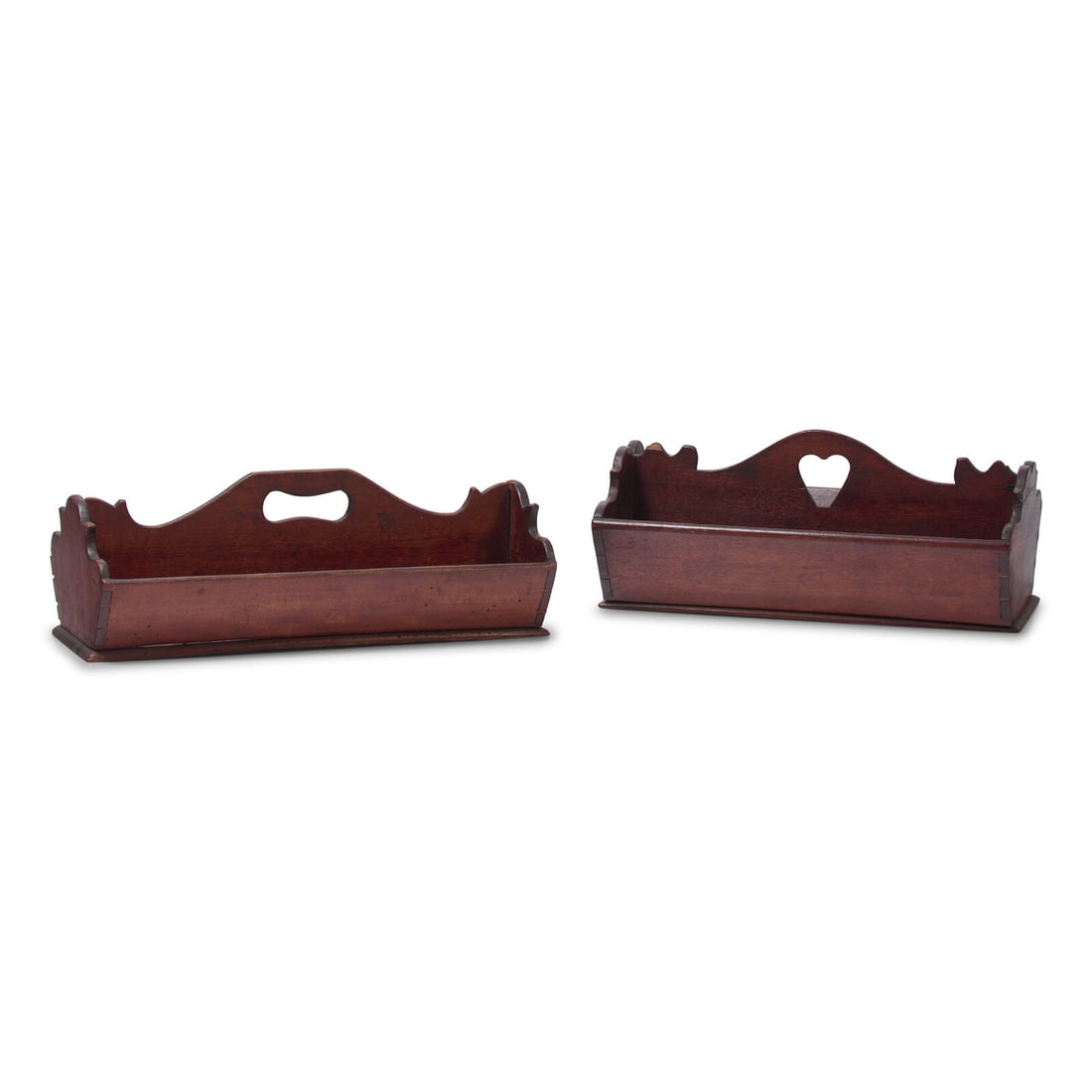 Two Carved Walnut and Cherry Cutlery Boxes: Two Carved Walnut and Cherry Cutlery Boxes Late 18th / Early 19th Century one with heart-shaped handle hold. Height 5 x width 13 x depth 8 1/4 inches (with heart). This lot is located in Philadelphia.