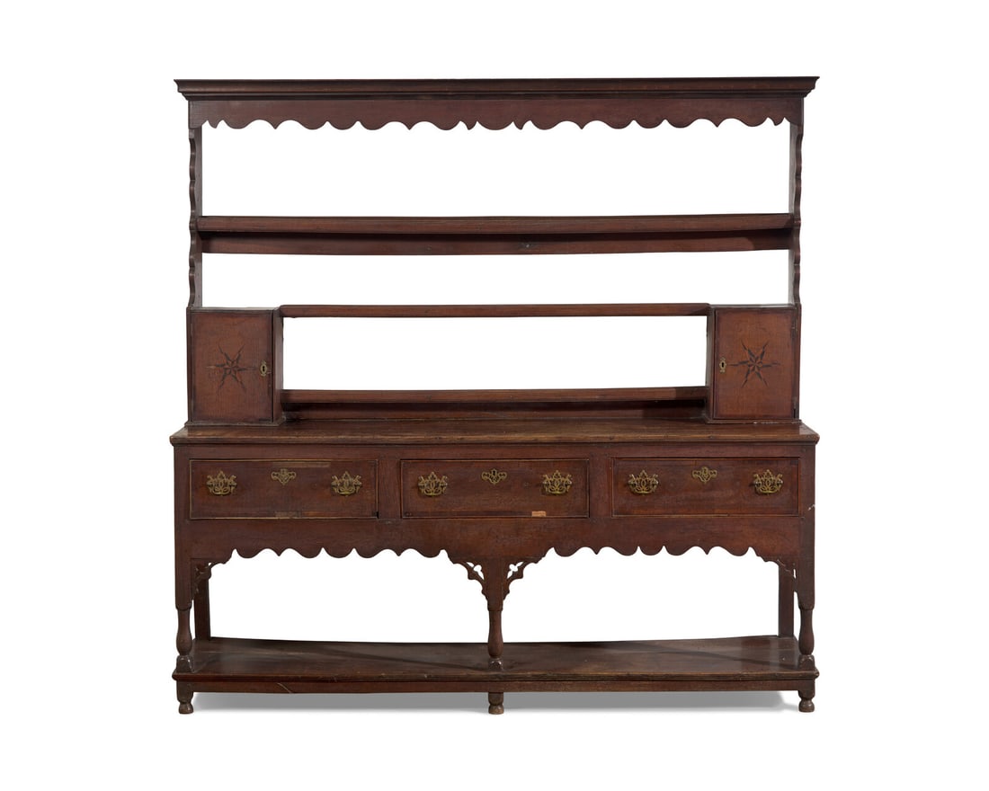 A Welsh George III Inlaid Oak Dresser: A Welsh George III Inlaid Oak Dresser Second Half 18th Century in two parts, the upper section with molded and scalloped cornice, with three plate racks, flanked by scalloped sides and two small