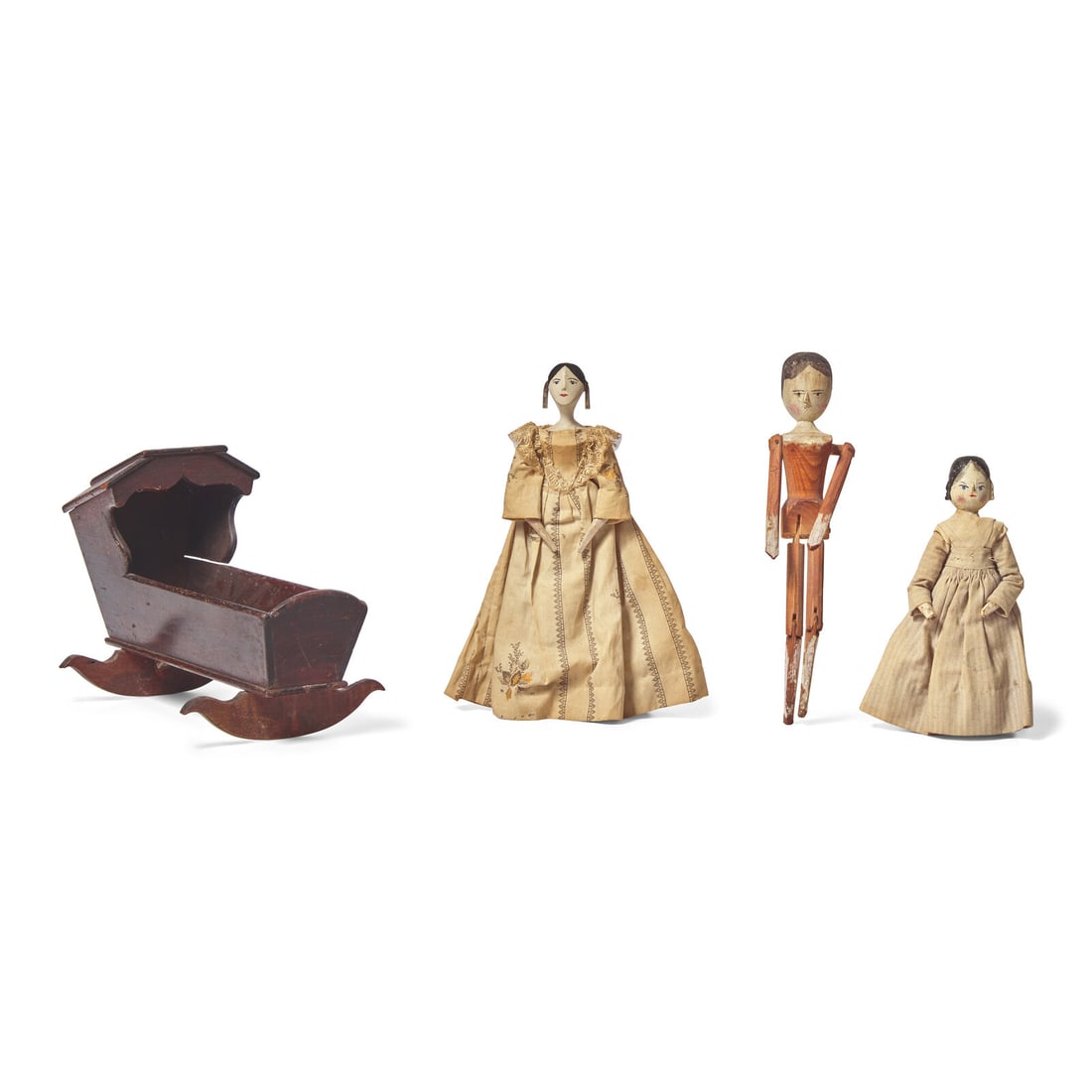 A Group of Three Peg Wooden Dolls and a Miniature Wood Cradle: A Group of Three Peg Wooden Dolls and a Miniature Wood Cradle The Dolls Likely from Val Gardena, South Tyrol, Italy, Circa 1850 two dolls with cotton dresses. Height 10 inches (tallest doll),