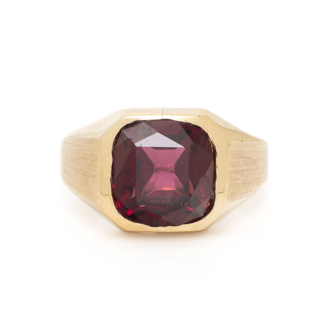 GARNET AND YELLOW GOLD RING: GARNET AND YELLOW GOLD RING Cushion cut garnet measuring approximately 11.15 x 10.75 x 6.55 mm. Yellow gold. Ring size 9. Gross weight: 6.40 dwt. This lot is located in Chicago.