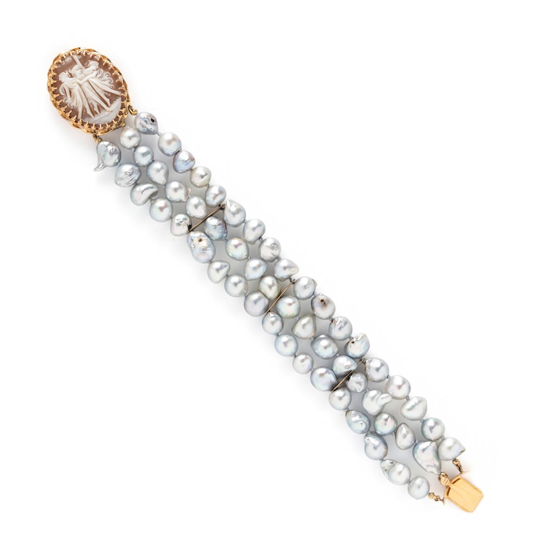 BAROQUE CULTURED GRAY PEARL AND SHELL CAMEO BRACELET: BAROQUE CULTURED GRAY PEARL AND SHELL CAMEO BRACELET Baroque cultured gray pearls measuring approximately 7.50 - 10.75 mm, with a 14 karat yellow gold clasp set with an oval shell cameo measuring