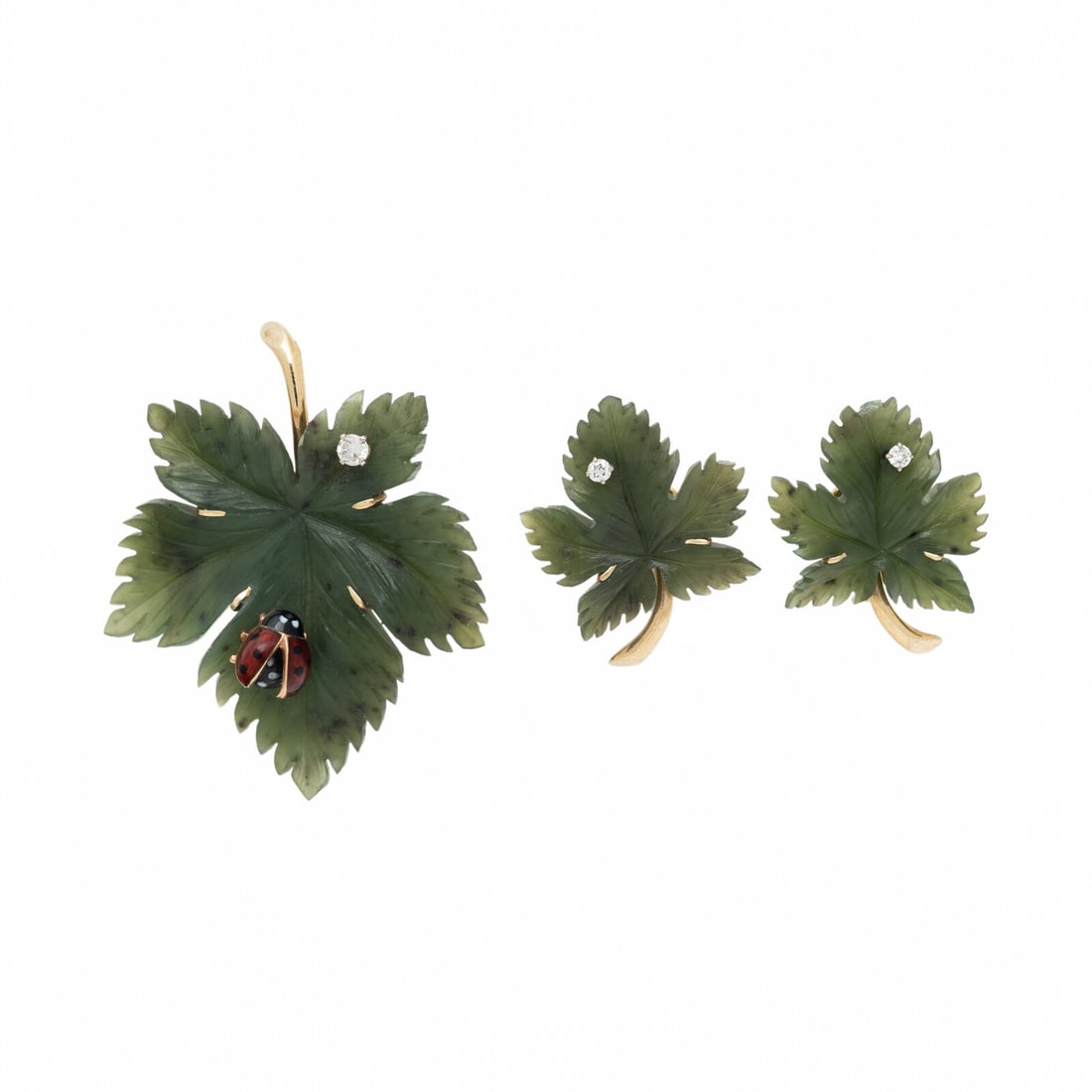 NEPHRITE JADE, DIAMOND, AND YELLOW GOLD CARVED LEAF EARRINGS AND BROOCH SET: NEPHRITE JADE, DIAMOND, AND YELLOW GOLD CARVED LEAF EARRINGS AND BROOCH SET Including a brooch with carved nephrite jade, enamel, and a round diamond, and a pair of earrings with carved nephrite jade