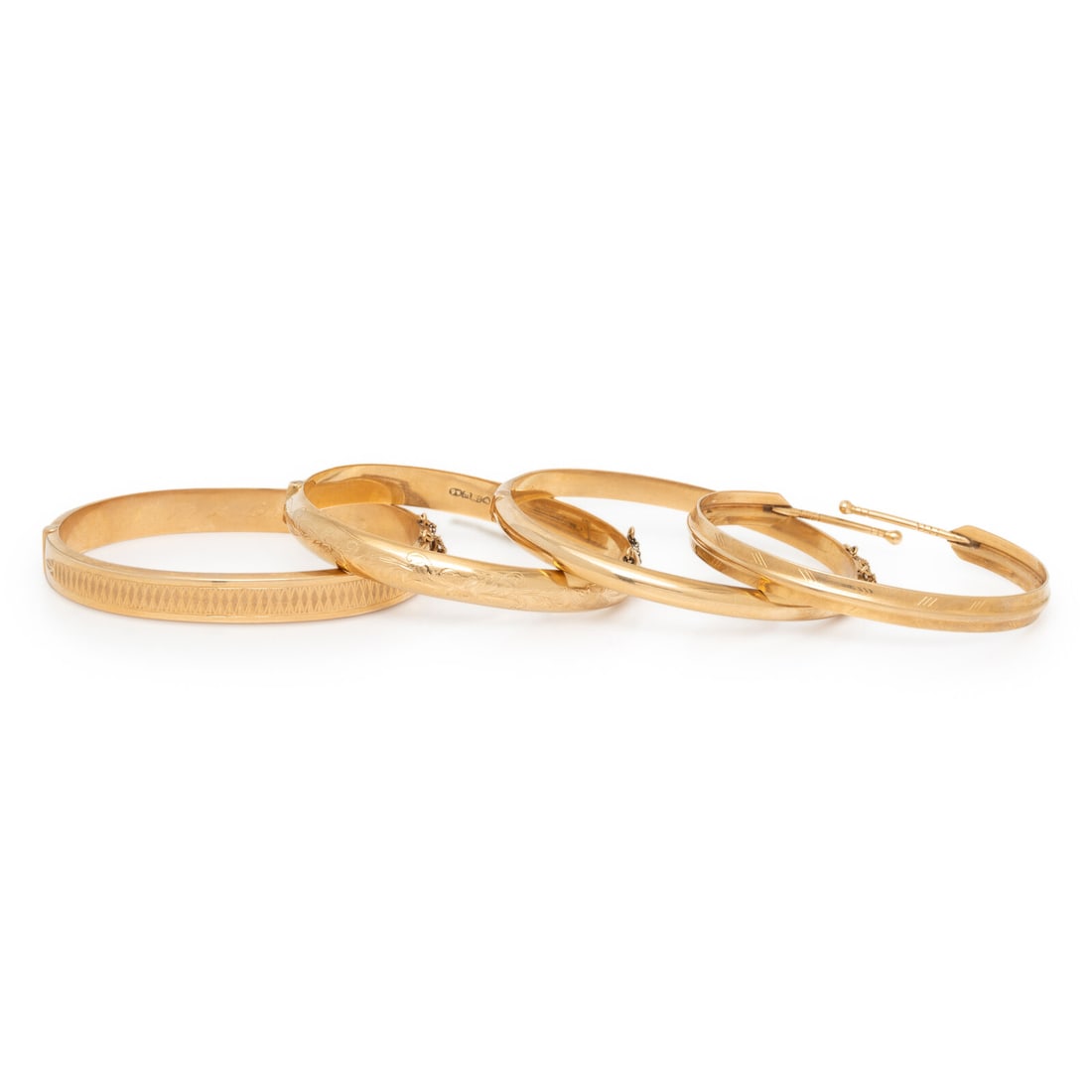FINNISH, COLLECTION OF FOUR YELLOW GOLD BANGLE BRACELETS: FINNISH, COLLECTION OF FOUR YELLOW GOLD BANGLE BRACELETS Three bangles hinged with side clasps, and one with a bypass design. 14 karat yellow gold. 6 3/8 -7 1/8 inches inner circumference. Stamp: (Fin