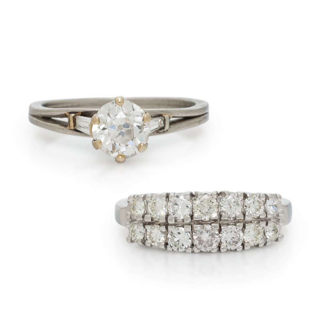 TWO DIAMOND RINGS: TWO DIAMOND RINGS Including a ring set with a old European cut diamond weighing approximately 0.95 carat and tapered baguette cut diamonds, and a band set with round diamonds weighing approximately