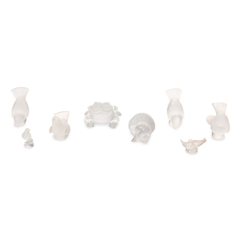 Eight Lalique Glass Animal Figurines: Eight Lalique Glass Animal Figurines 20th Century comprising a frog, hedgehog, four birds, parakeet and a figure of two lovebirds. Height of first 3 x width 4 1/4 x depth 4 1/4 inches. Property