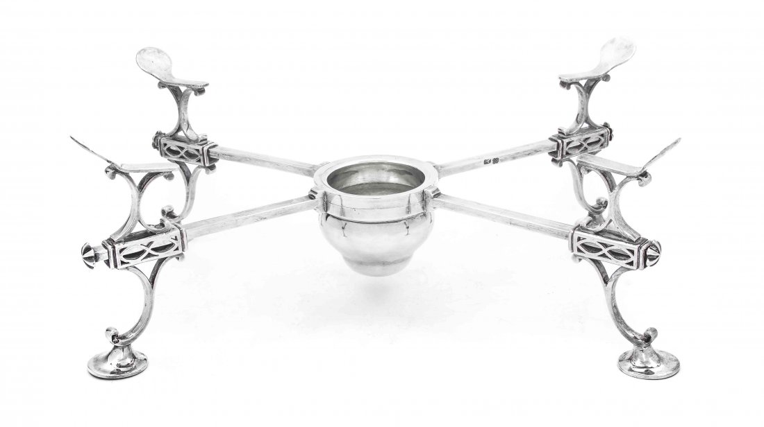 A George III Silver Warming Cross, Charles Aldridge & H: A George III Silver Warming Cross, Charles Aldridge & Henry Green, London, 1773, centered with a burner compartment, engraved with the crest of an armored hand grasping a clover or a cross, having adj