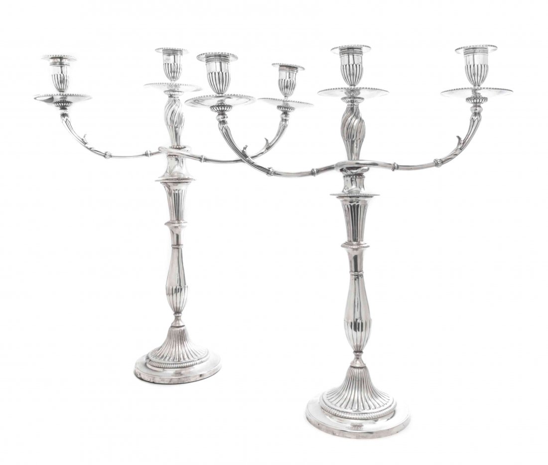 A Pair of George III Silver Candlesticks, John Green, R: A Pair of George III Silver Candlesticks, John Green, Roberts, Mosley & Co., Sheffield, 1808, of baluster form with reeded decoration, together with a pair of Victorian silver three-light candelabra i