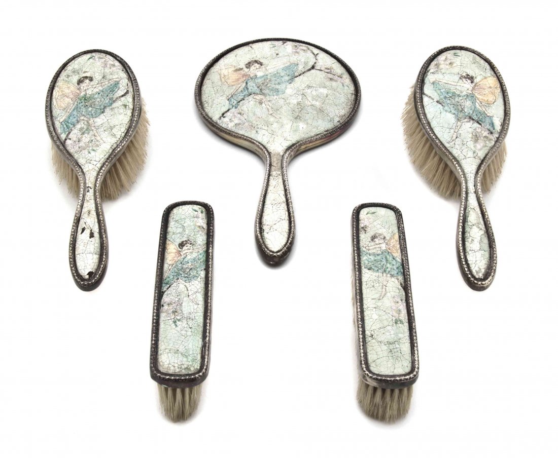 An English Arts & Crafts Silver Mounted Dresser Set, He: An English Arts & Crafts Silver Mounted Dresser Set, Henry Clifford Davis, Birmingham, 1902, comprising four brushes and a hand mirror. Length of longest 10 1/2 inches.