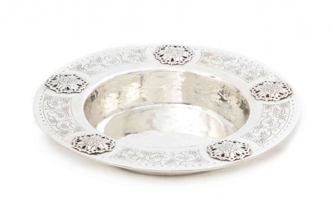 An George V Silver Ash Receiver, Liberty & Co., Diamete: An George V Silver Ash Receiver, Liberty & Co., Birmingham, 1927, of circular form with applied and incised stylized foliate decoration, numbered 5843; approximate weight 3.89 ozt. Diameter 5 1/2 inch