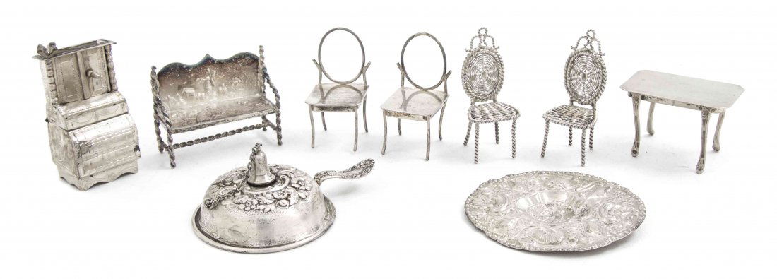 A Collection of Miniature Silver Articles, Height of ta: A Collection of Miniature Silver Articles, comprising a set of two chairs and a dining table, marked Sterling, a chamberstick by Dominick & Haff, numbered 282, a Continental bench, marked B2S, and a D