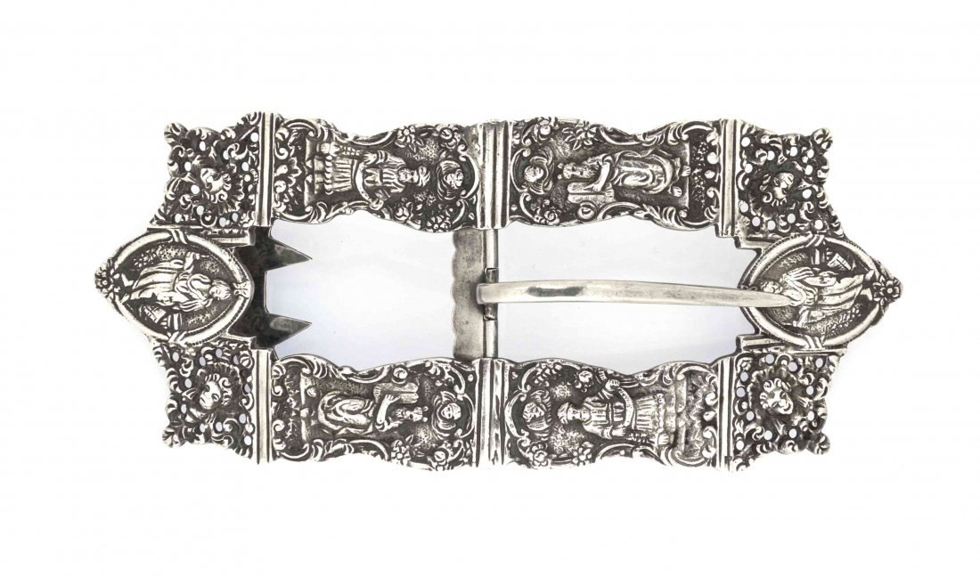 A Sterling Silver Belt Buckle, Width 6 1/4 inches.: A Sterling Silver Belt Buckle, late 19th century, of curved rectangular form, cast in the Dutch style with cartouches of biblical figures, marked Sterling; approximate weight 3.73 ozt. Width 6 1/4 inc