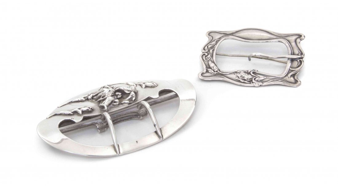 Two American Sterling Silver Art Nouveau Belt Buckles, : Two American Sterling Silver Art Nouveau Belt Buckles, both decorated with irises, comprising an oval William B. Kerr example, and a shaped rectangular buckle mounted with a later pin stem, marked Ste