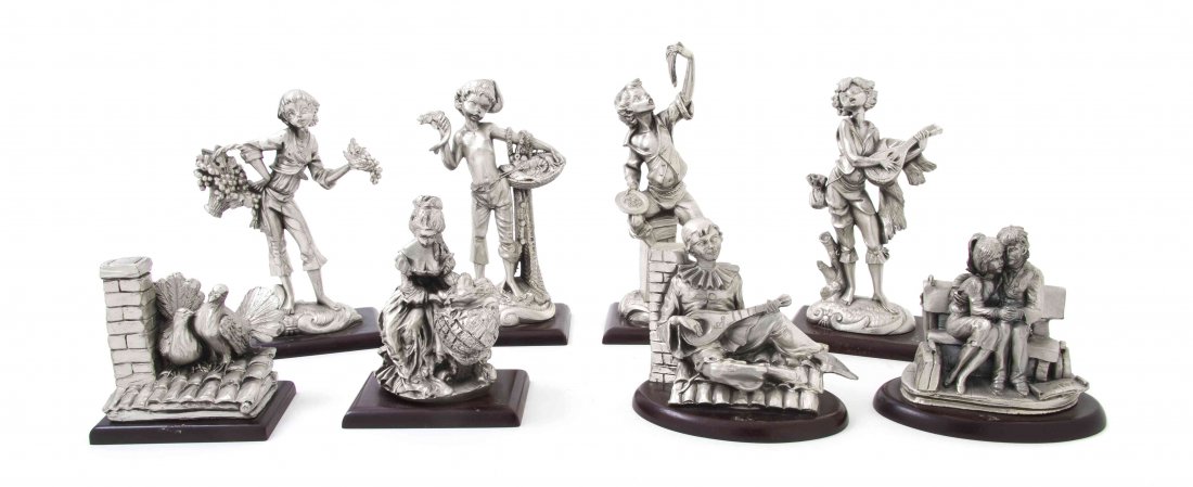 A Collection of Eight Italian Silver Figures and Figura: A Collection of Eight Italian Silver Figures and Figural Groups, comprising four of boys, including one with grapes, another with seafood, one with pasta and the last playing a mandolin, a clown playi