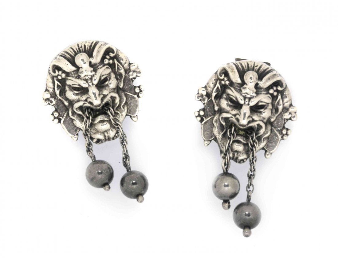 A Pair of American Sterling Silver Fur Clips, Cini, Hei: A Pair of American Sterling Silver Fur Clips, Cini, Boston, each formed as a Renaissance Revival satyr mask, suspending short chains ending in a bead, with double pin stems; approximate total weight 0