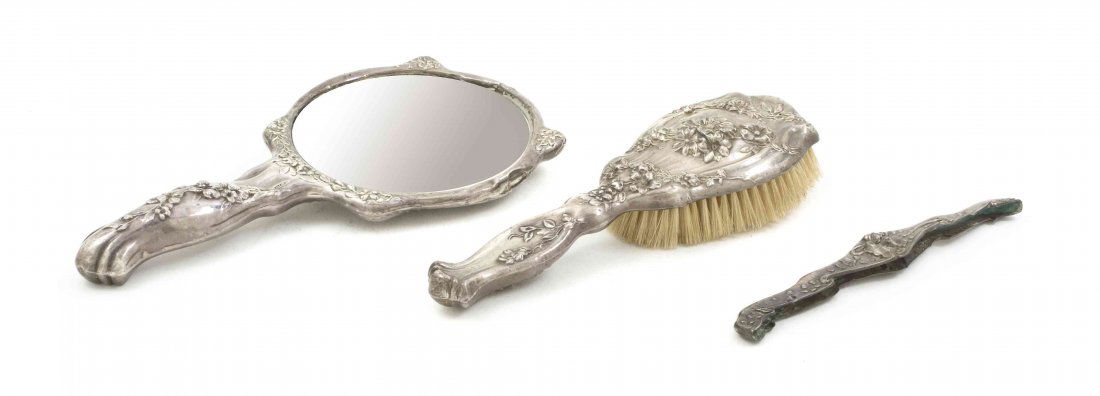 An American Sterling Silver Vanity Set, Length of first: An American Sterling Silver Vanity Set, comprising a brush, a hand mirror and a comb. Length of first 9 inches. Property from the Dr. Myrna Salud Living Trust, Marion, Indiana