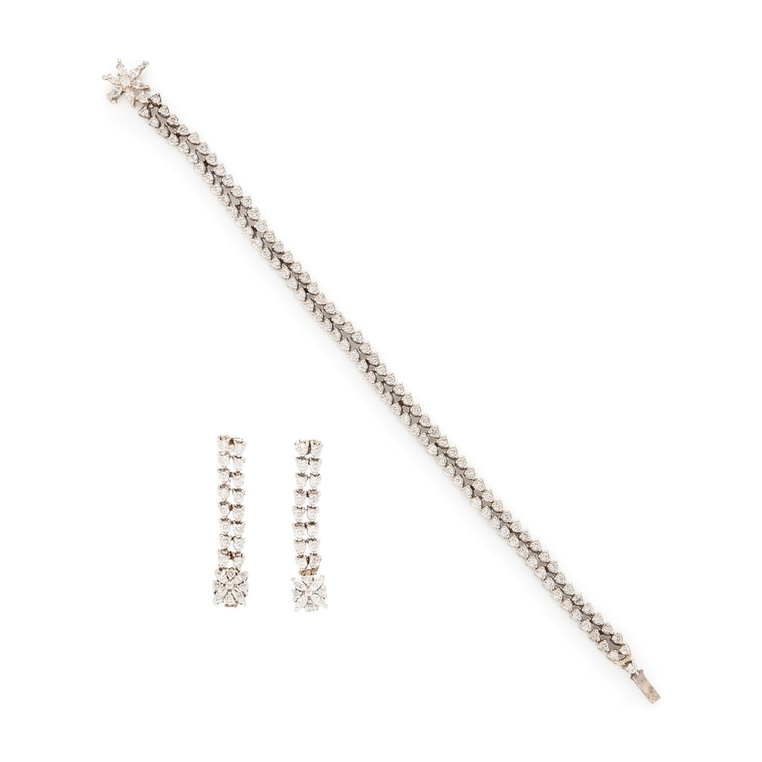 DIAMOND AND WHITE GOLD FLOWER BRACELET AND EARRINGS: DIAMOND AND WHITE GOLD FLOWER BRACELET AND EARRINGS Including a bracelet set with round and marquise cut diamonds weighing approximately 4.40 carats total, and a pair of earrings set with round and ma