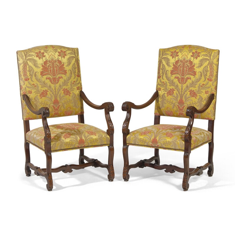 A Pair of Louis XIV Style Carved Mahogany Fauteuils: A Pair of Louis XIV Style Carved Mahogany Fauteuils 20th Century Each with arched crest rail over padded back, scrolling arms with acanthus-carved knuckles, conformingly carved feet connected by H-for